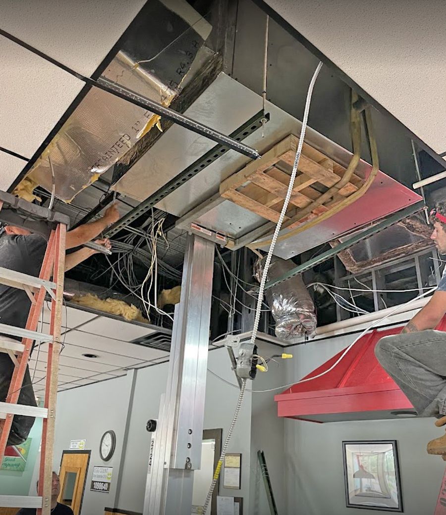 Arctic Air crew installing ductwork at a commercial building