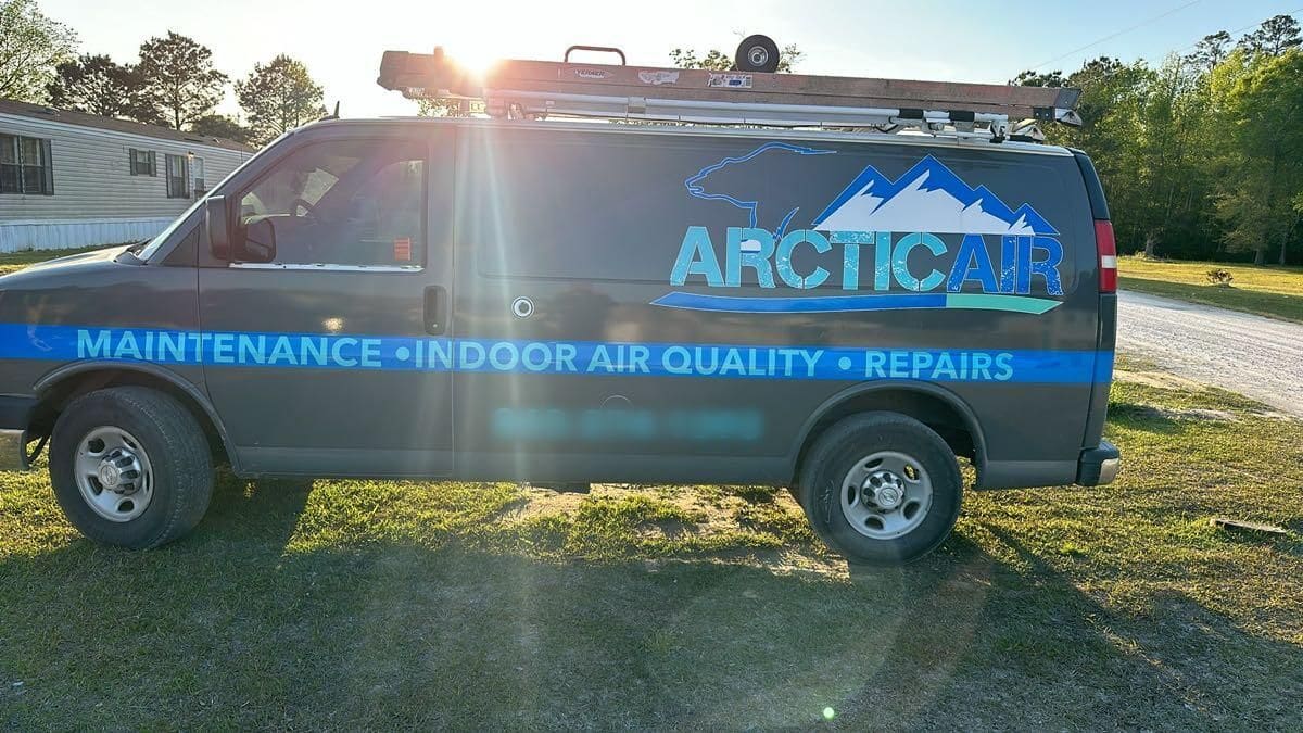 Arctic Air work van with the polar bear logo and a ladder rack