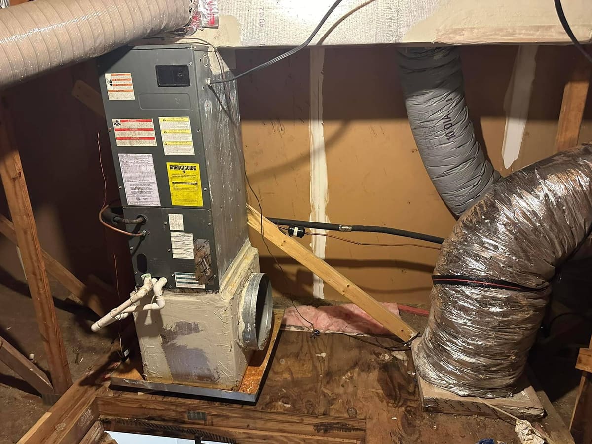 Air handler on a platform under a house with silver flex duct