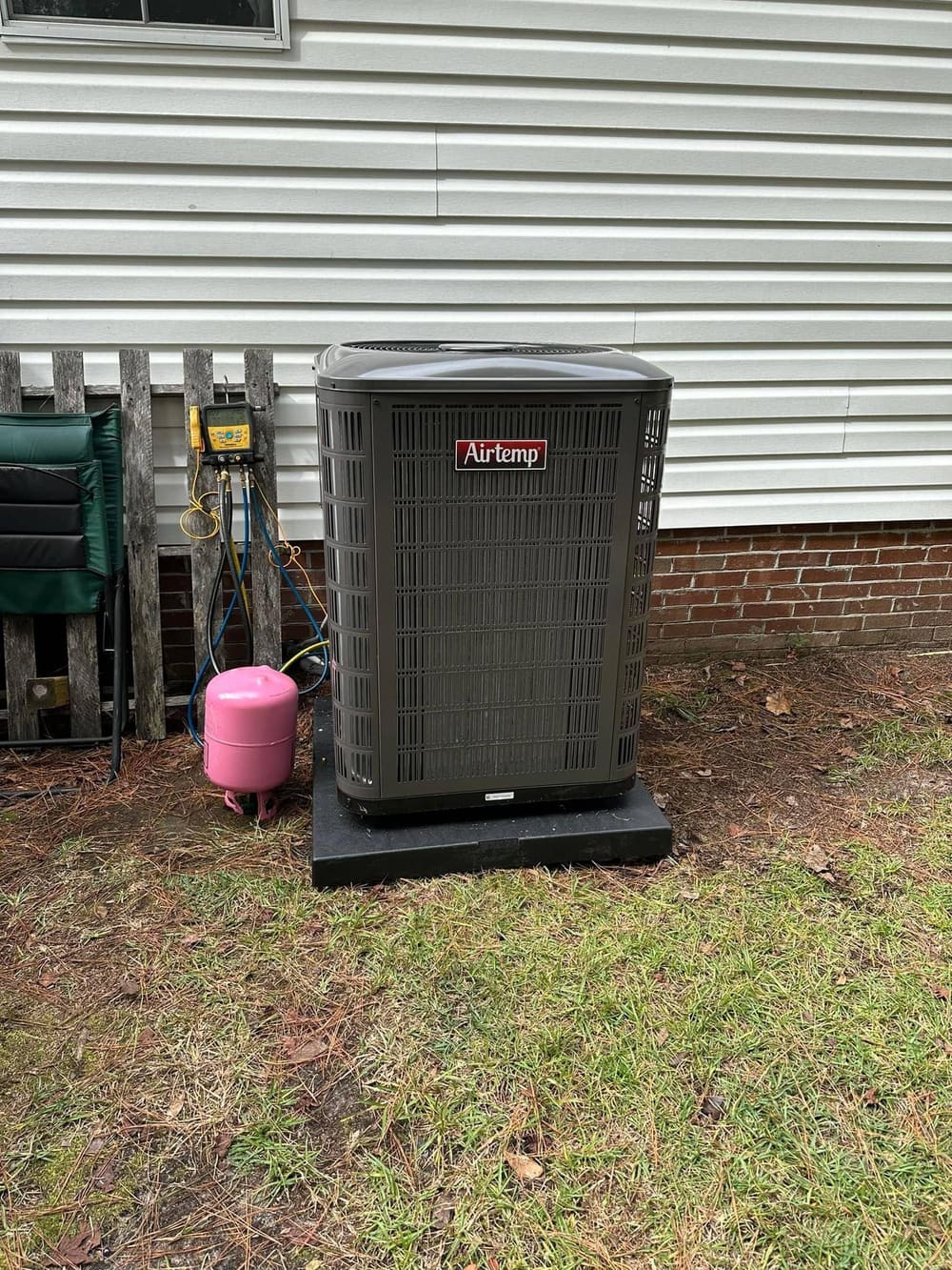 New outdoor condenser with a refrigerant tank beside it