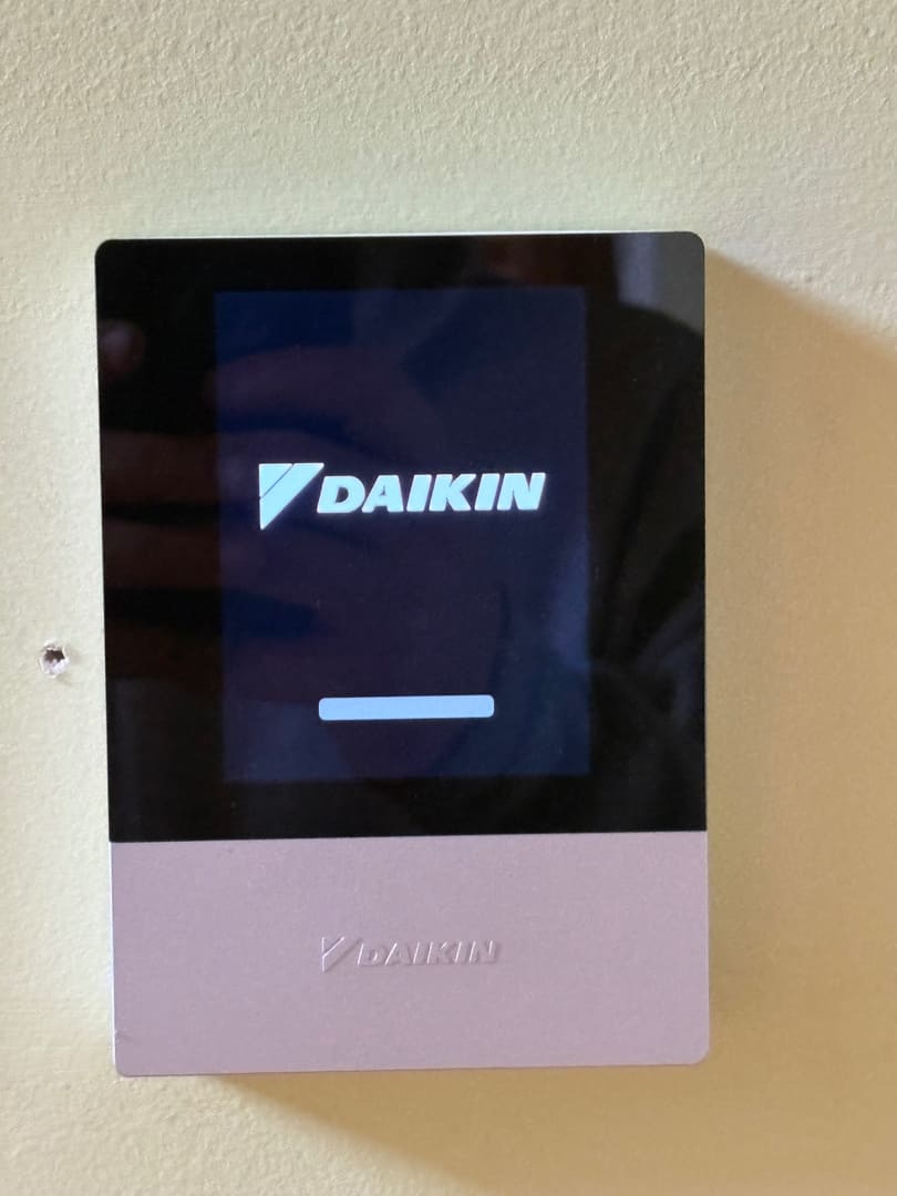 Daikin thermostat starting up on a wall