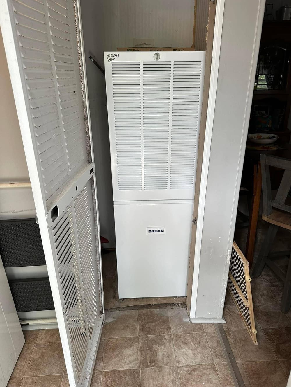 White furnace cabinet in a louvered closet