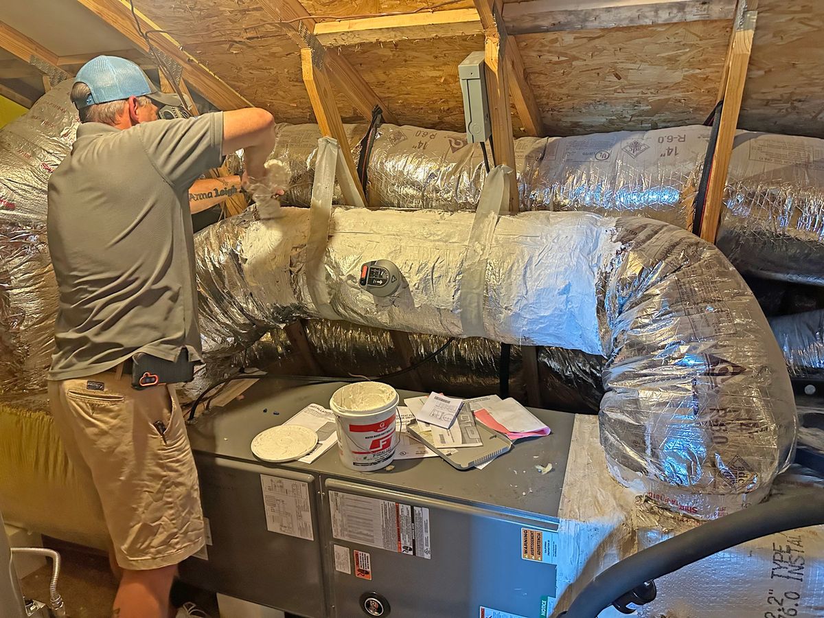 Arctic Air technician installing attic ductwork and air handler in Conway SC