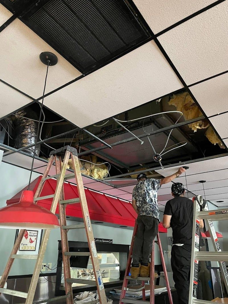 Arctic Air crew installing commercial ductwork from ladders